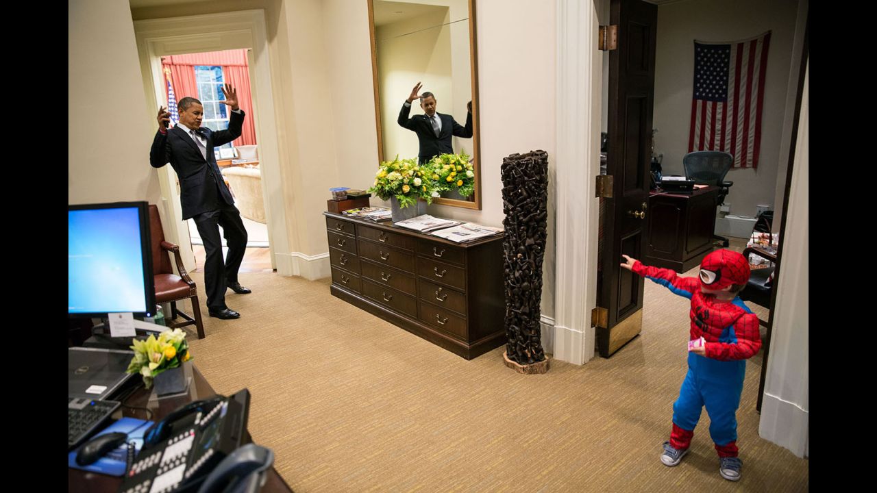 Obama pretends to be caught in Spider-Man's web as he interacts with Nicholas Tamarin, 3, just outside the Oval Office on October 26, 2012. Nicholas, son of White House aide Nate Tamarin, had been out trick-or-treating. "The President told me that this was his favorite picture of the year when he saw it hanging in the West Wing a couple of weeks later," White House photographer Pete Souza said.