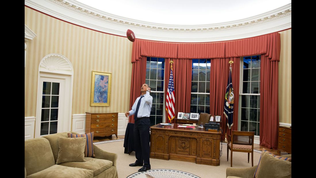 Obama tosses a football in the Oval Office on January 6, 2014.