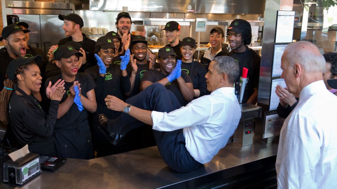 Obama slides across a counter to pose with staff members at a Shake Shack restaurant in Washington on May 16, 2014. Vice President Joe Biden, lower right, also did the same. "The President normally does a group photo with restaurant staff when he stops for lunch or dinner," White House Photographer Pete Souza said.