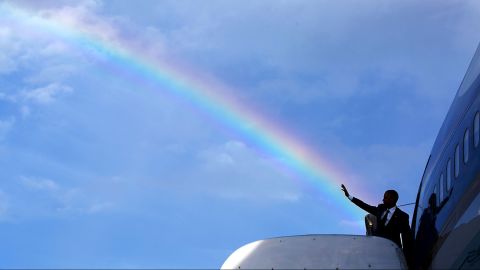 Obama's wave aligns with a rainbow as he boards Air Force One in Kingston, Jamaica, on April 9, 2015.