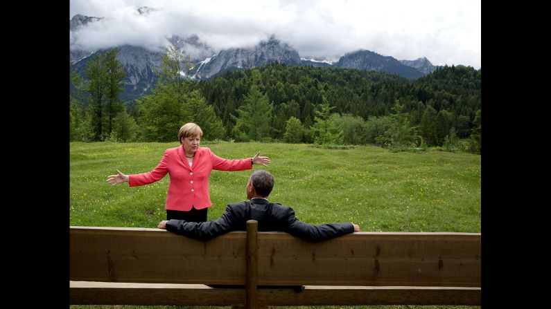 German Chancellor Angela Merkel talks with Obama <a href="index.php?page=&url=http%3A%2F%2Fwww.cnn.com%2F2015%2F06%2F08%2Fpolitics%2Fbarack-obama-angela-merkel-photo-germany-mountains%2F" target="_blank">near the Bavarian Alps</a> on June 8, 2015. Obama and other world leaders were in Germany for the annual G-7 Summit. "Merkel asked the leaders and outreach guests to make their way to a bench for a group photograph," White House Photographer Pete Souza said. "The President happened to sit down first, followed closely by the Chancellor. I only had time to make a couple of frames before the background was cluttered with other people."