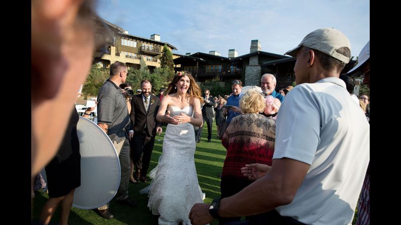 Obama was playing golf in La Jolla, California, where a wedding ceremony was about to begin on October 11, 2015. "The bride and groom were waiting inside, but when they looked out the window and saw the President, they decided to make their way outside," White House photographer Pete Souza said. Souza sent a copy of the photograph to the couple, Brian and Stephanie Tobe. "Both wrote back to me that they were extremely grateful to have the President <a href="index.php?page=&url=http%3A%2F%2Fwww.cnn.com%2F2015%2F10%2F13%2Fliving%2Fpresident-obama-crashes-california-wedding%2F" target="_blank">'crash' their wedding."</a>
