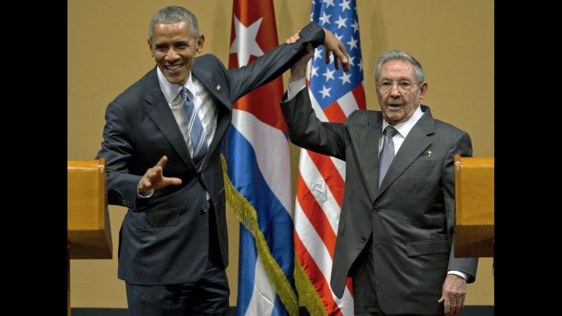 Cuban President Raul Castro tries to lift up Obama's arm at the end of a joint news conference in Havana, Cuba, on March 21, 2016. Obama became the first sitting U.S. President to visit Cuba since 1928, and he <a href="index.php?page=&url=http%3A%2F%2Fwww.cnn.com%2F2016%2F03%2F22%2Fpolitics%2Fobama-cuba-change-speech-embargo%2F" target="_blank">called for the U.S. embargo against Cuba to be lifted.</a>