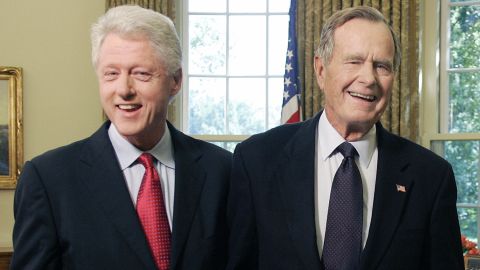 Former US Presidents George H.W. Bush and Bill Clinton smile as they leave the Oval Office on September 1, 2005 at the White House in Washington, DC.