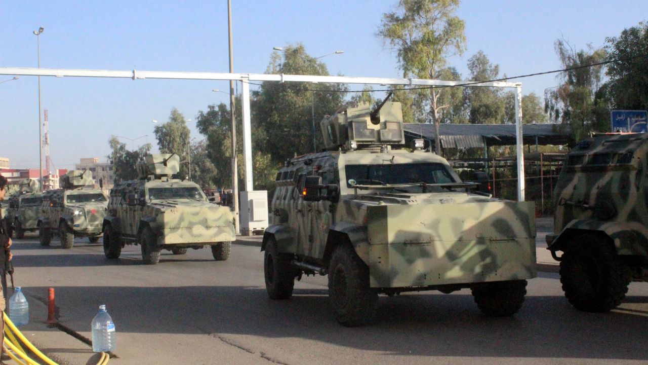 Security forces arrive with armored vehicles Friday after ISIS attacks in Kirkuk, Iraq.