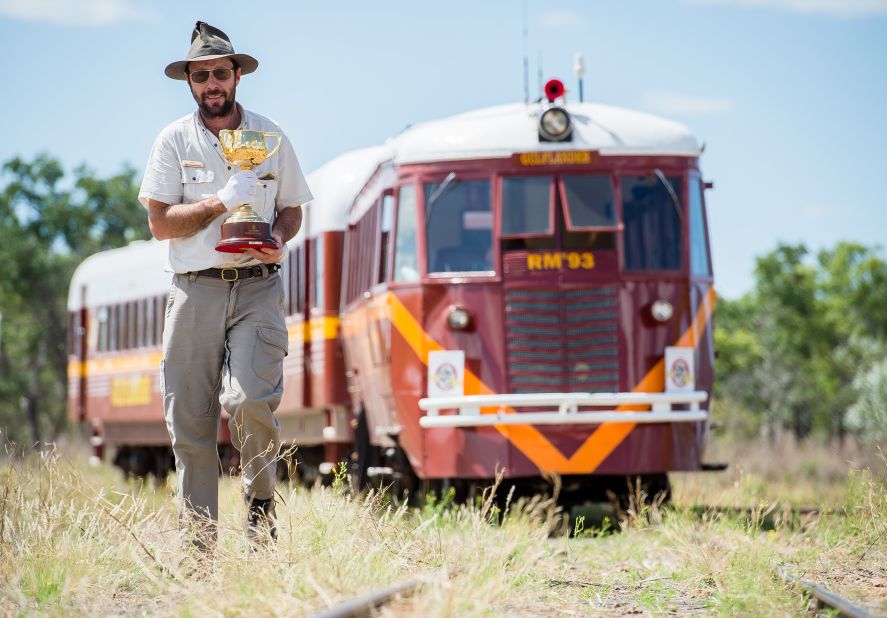 Train driver Ken Fairbairn with the Cup in front of the Gulflander train outside Croydon, outback Queensland.