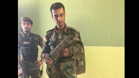 Captain Chilhan Sadk of the Peshmerga handles a diffused ISIS-made suicide belt.