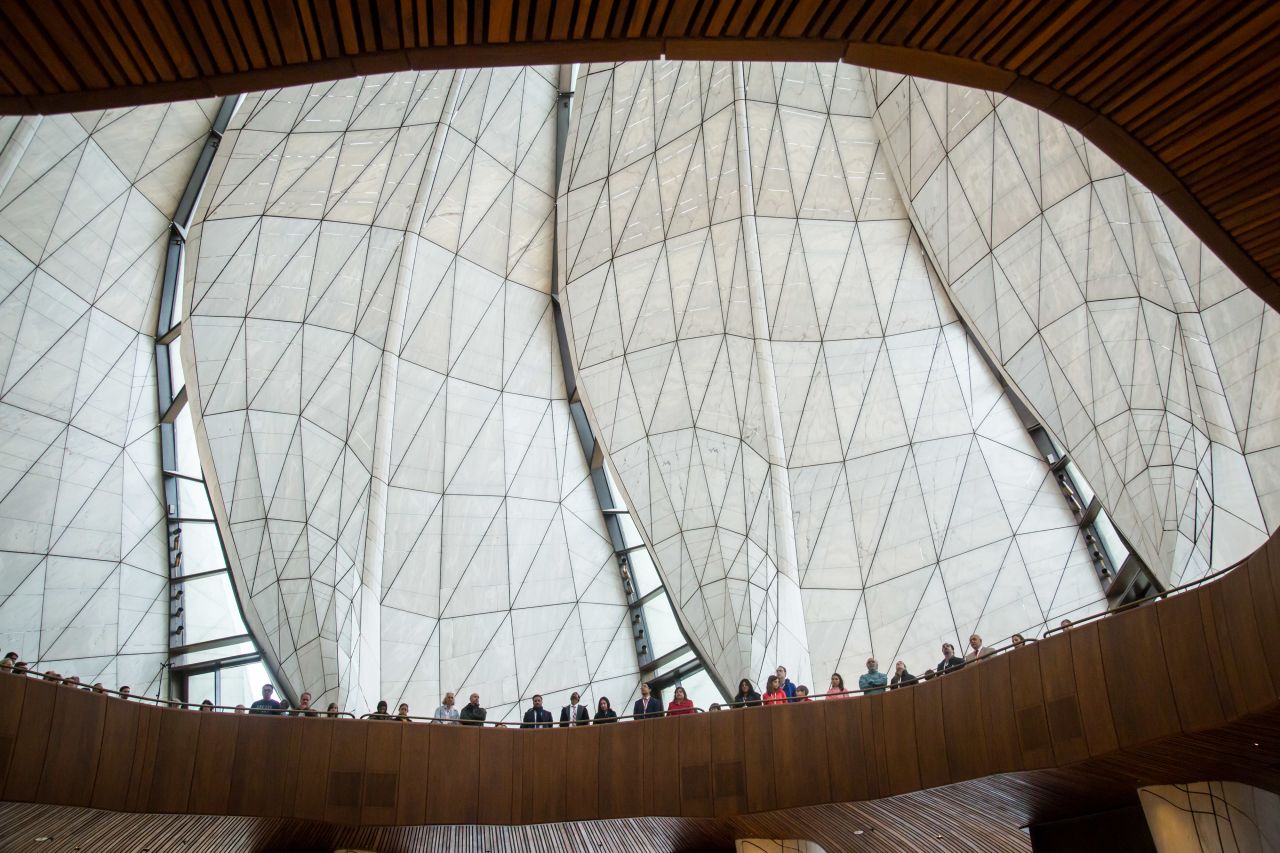 Nine wing-like panels of translucent cast glass form the temple dome, converging 90 feet above the ground.
