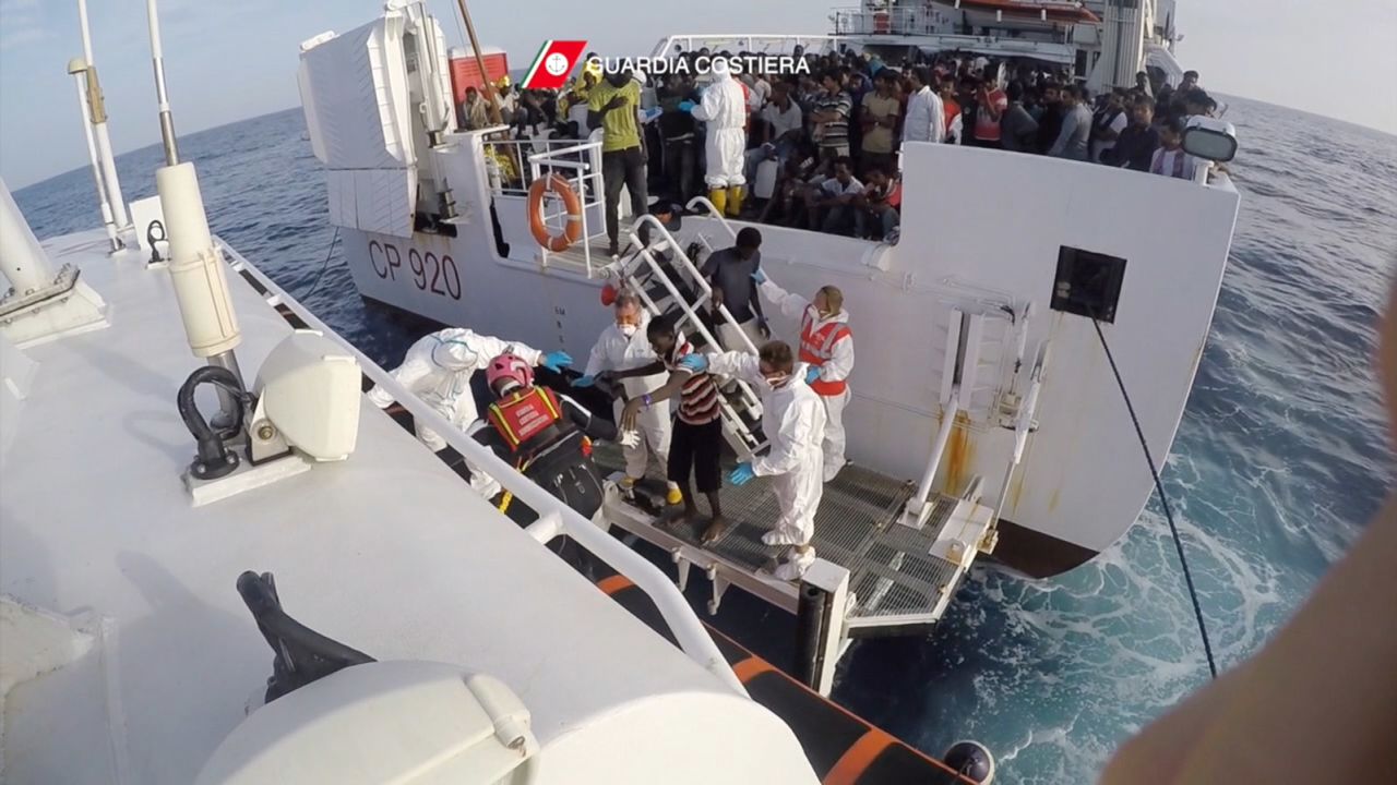 Rescued migrants are transferred from the Italian coast guard ship Gregoretti to a dinghy Friday. 