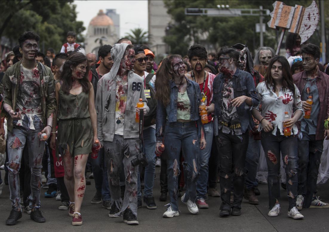 People dressed in rags and ghoulish makeup take part in the annual Zombie Walk in Mexico City on Saturday, October 22.