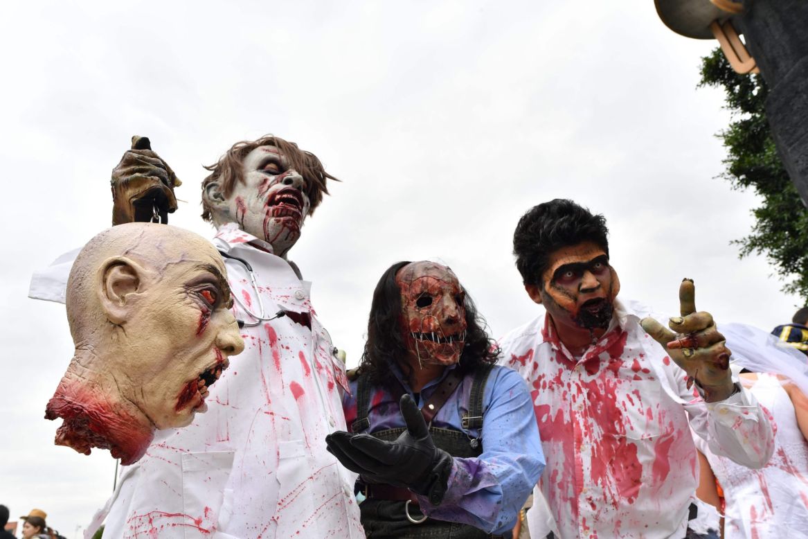 A group of zombies show off their ghoulish prize. 