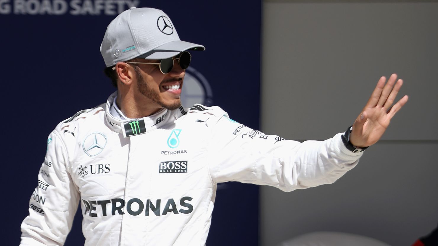 Lewis Hamilton waves after qualifying in pole position for the United States Grand Prix at Circuit of The Americas in Austin, Texas.