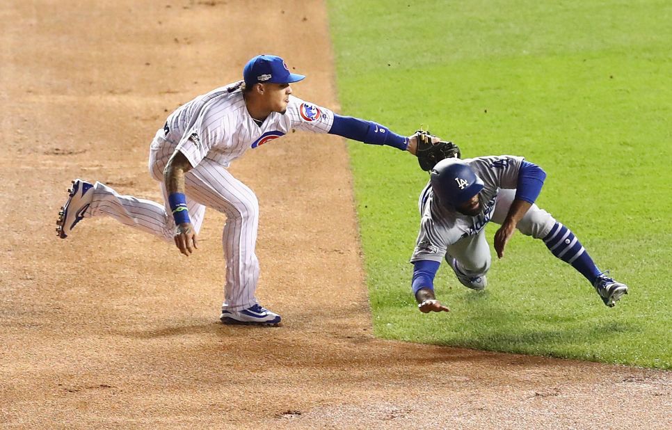 Javier Baez of the Cubs tags out Andrew Toles of the Dodgers at second base in the first inning.