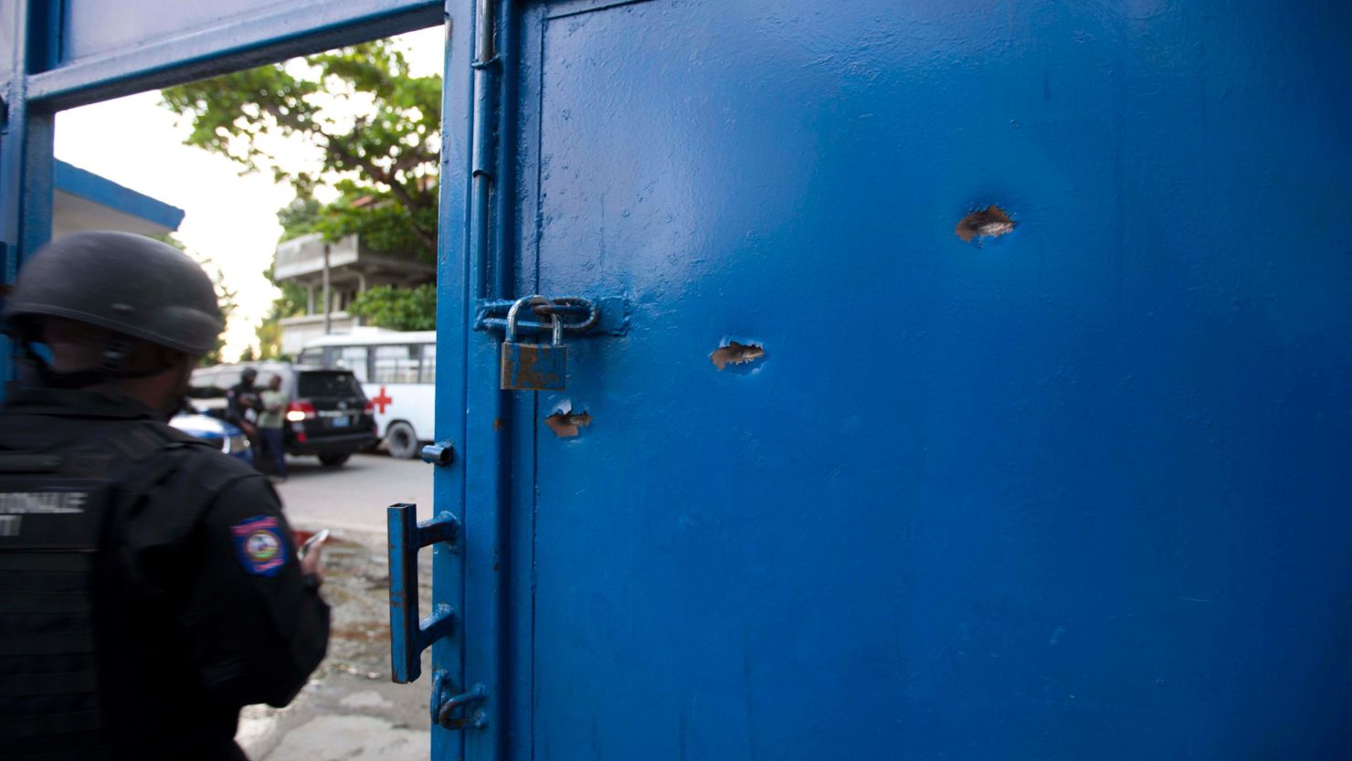 Bullet holes pierce the main gate of the Civil Prison after a jail break in the coastal town of Arcahaiea, Haiti.