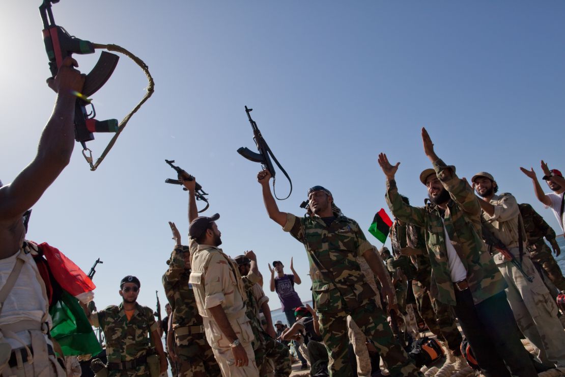 Rebel fighters celebrate the fall of the Gadhafi government in Tripoli in 2011