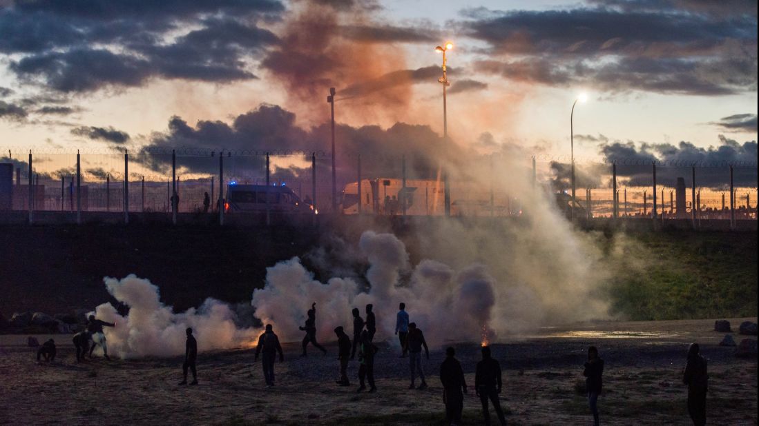 French police fire tear gas after refugees reportedly threw rocks at police vans near the camp on Saturday, October 22.