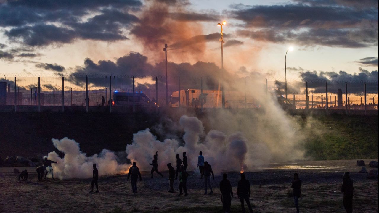 French police fire tear gas after refugees reportedly threw rocks at police vans near the camp on Saturday, October 22.