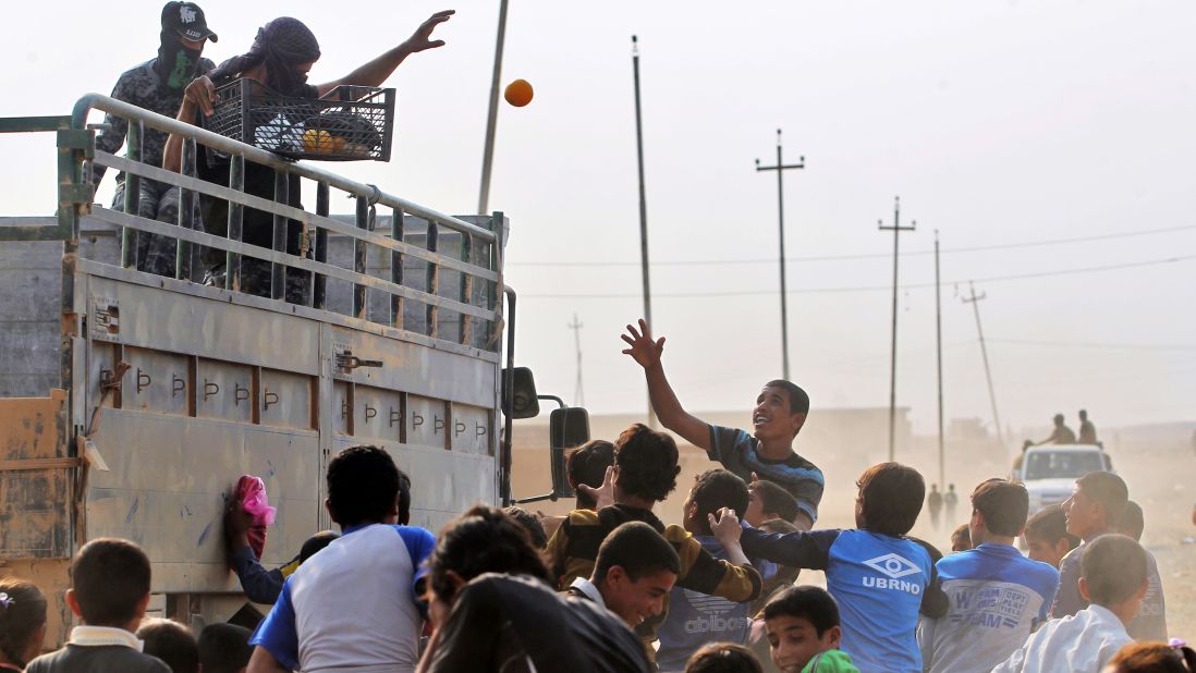 Iraqi forces distribute fruit in the village of al-Khuwayn, south of Mosul, after recapturing it from ISIS on October 23.