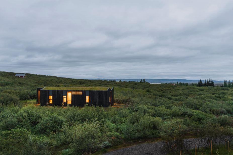 Tucked away in a lush hillside of Brekkuskógur, Iceland, BHM Vacation Rental Cottages by PK Arkitektar blend into the surrounds, thanks to burnt hardwood paneling and green rooftops that seem to fuse with the landscape.