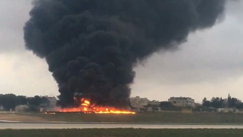 Smoke billows into the sky after a light plane crashed soon after takeoff from Malta airport, in Valletta.