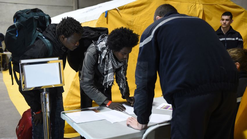 Migrants register before boarding buses for shelters across France, as part of the full evacuation of the Calais "Jungle" camp, in Calais, northern France, on October 24, 2016.
French authorities are set to begin on October 24, 2016 moving thousands of people out of the notorious Calais Jungle before demolishing the camp that has served as a launchpad for attempts to sneak into Britain. A major three-day operation is planned to clear the sprawling shanty town near Calais port -- a symbol of Europe's failure to resolve its migrant crisis -- of its estimated 6,000-8,000 occupants. The current Jungle camp dates from April 2015 and housed more than 10,000 migrants at its peak, although that number has dwindled to around 5,000 in its final days. / AFP / DENIS CHARLET        (Photo credit should read DENIS CHARLET/AFP/Getty Images)