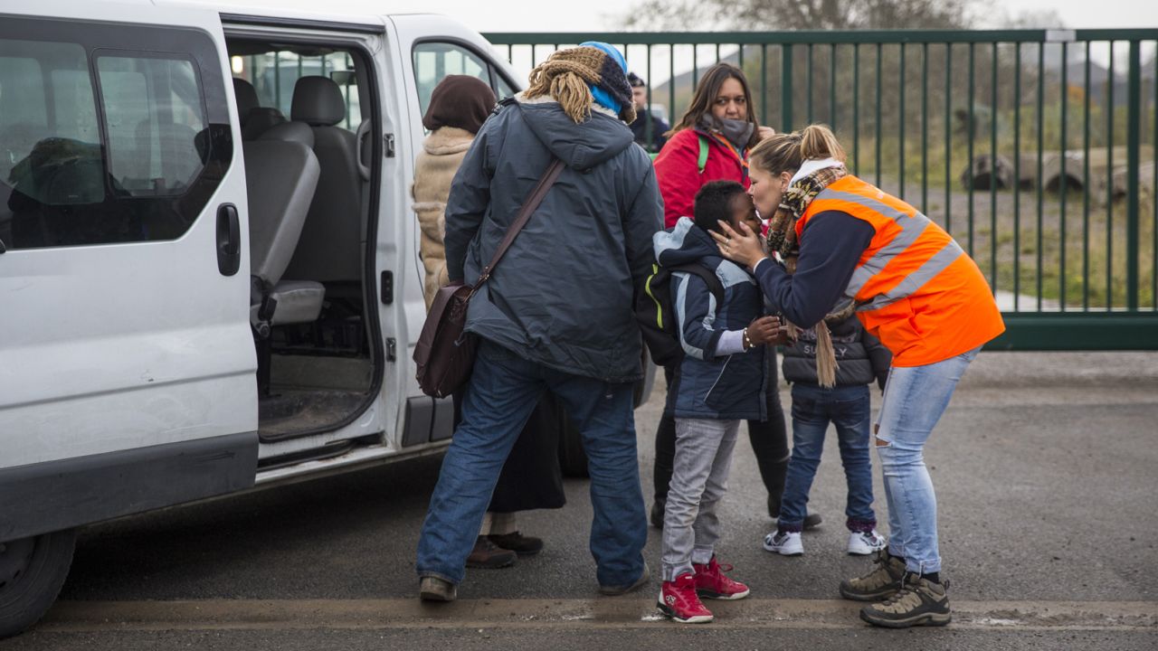 CALAIS, FRANCE - OCTOBER 24: Care workers bring child migrants to a reception point outside the Jungle migrant camp before boarding buses to refugee centres around France on October 24, 2016 in Calais, France. French authorities have begun to clear the estimated 7000 people from the Jungle migrant and refugee camp ahead of its demolition. (Photo by Jack Taylor/Getty Images)