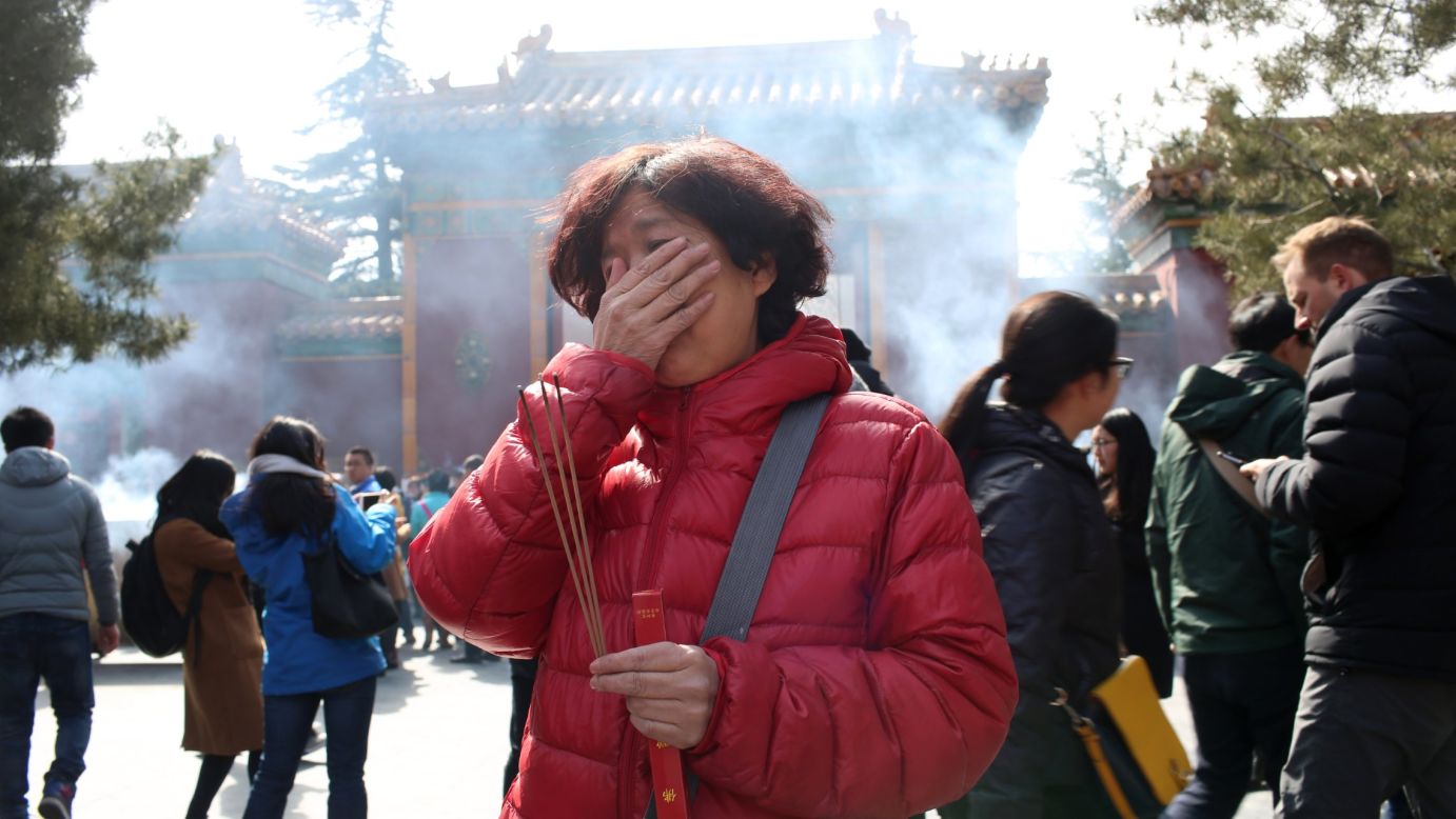 Two years after Malaysia Airlines Flight 370 went missing, a relative of one of the passengers burns incense in Beijing on March 8, 2016. Flight 370 vanished on March 8, 2014, as it flew from Kuala Lumpur, Malaysia, to Beijing. There were 239 people on board.