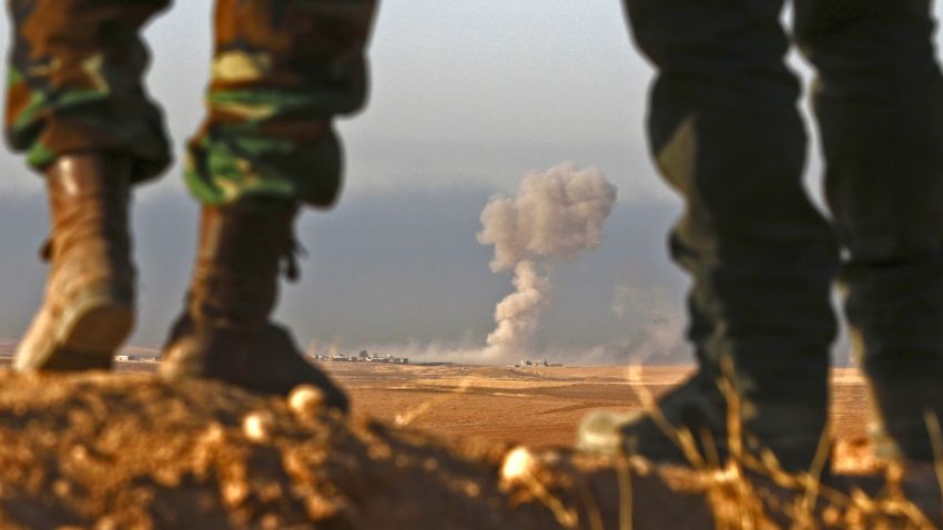 TOPSHOT - Iraqi Kurdish Peshmerga fighters stand in an area near the town of Bashiqa, some 25 kilometres north east of Mosul, as smoke billows on October 20, 2016, during an operation against Islamic State (IS) group jihadists to retake the main hub city.
Kurdish forces launched a fresh push against areas held by the Islamic State group around Mosul, pressing an offensive to retake the jihadists' last major stronghold in Iraq. / AFP / SAFIN HAMED        (Photo credit should read SAFIN HAMED/AFP/Getty Images)
