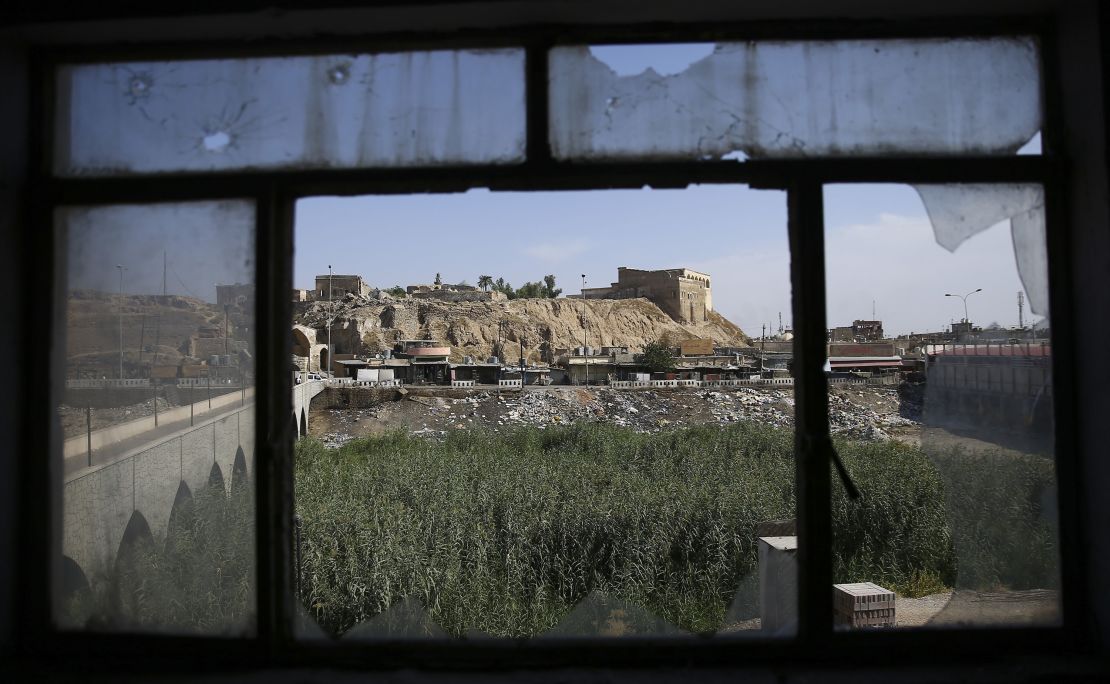 A view of Kirkuk is seen through the broken window of Jihad Hotel on October 22. ISIS used the hotel as a base during an attack in Kirkuk on Friday.