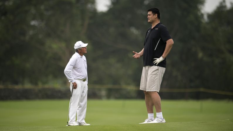 Golf legend Gary Player, left, and basketball Hall of Famer Yao Ming talk during a celebrity pro-am in Haikou, China, on Sunday, October 23. Yao is 7 feet, 6 inches -- a full 2 feet taller than Player.
