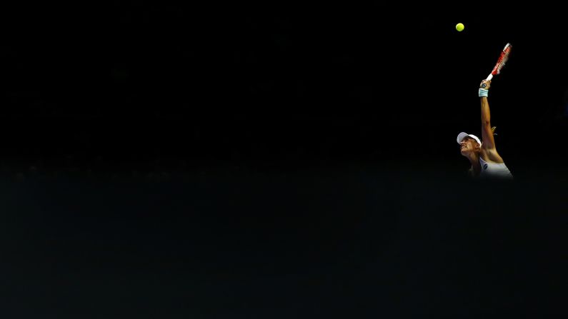 A shaft of light hits Angelique Kerber as she plays a <a href="index.php?page=&url=http%3A%2F%2Fwww.cnn.com%2F2016%2F10%2F21%2Ftennis%2Fserena-williams-kerber-wta-finals-singapore%2Findex.html" target="_blank">WTA Finals</a> match in Singapore on Sunday, October 23.