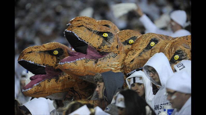 Dinosaur heads are seen in the Penn State student section during the football game against Ohio State on Saturday, October 22.