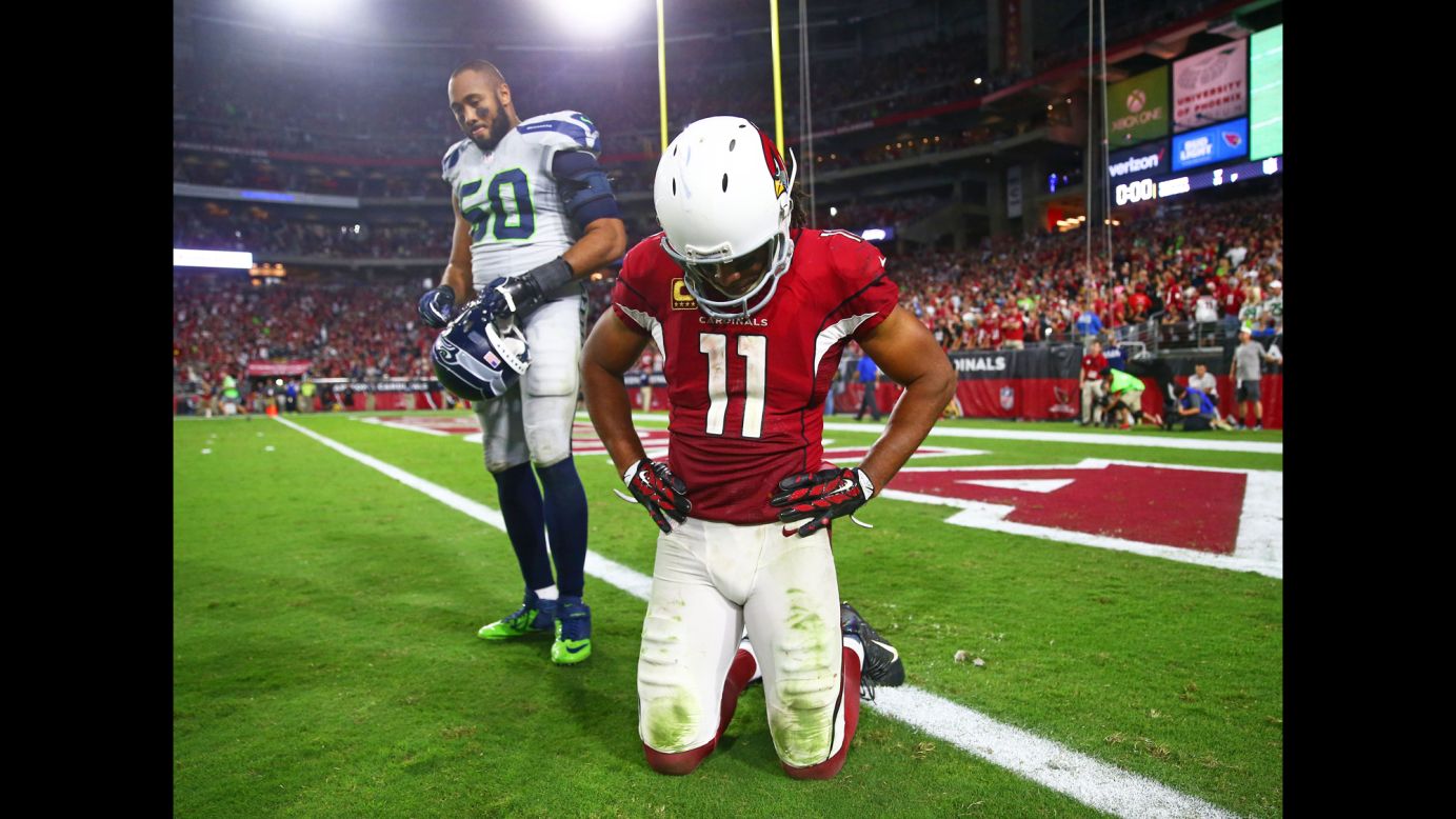 Seattle linebacker K.J. Wright, left, and Arizona wide receiver Larry Fitzgerald react after their teams tied 6-6 on Sunday, October 23. Both teams missed short field goals late in overtime.