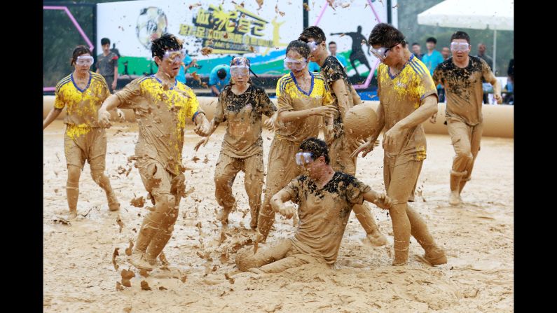 People play in the mud Friday, October 21, during a "swamp soccer" tournament in Chengdu, China.