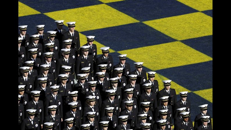 Members of the U.S. Naval Academy stand in formation before a college football game in Annapolis, Maryland, on Saturday, October 22.