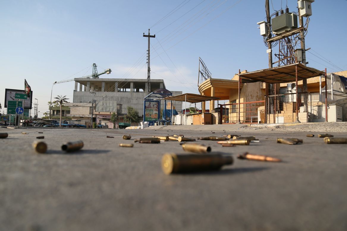 Spent bullet cartridges litter the street around the Jihad Hotel, where ISIS militants battled Iraqi security forces in Kirkuk on Friday, October 21.