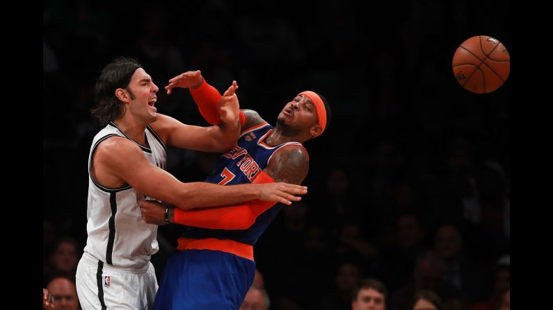 Brooklyn's Luis Scola, left, knocks the ball away from New York's Carmelo Anthony during an NBA preseason game on Thursday, October 20.