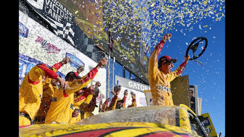 Joey Logano and his crew celebrate in Victory Lane after winning the NASCAR Sprint Cup race in Talladega, Alabama, on Sunday, October 23. 