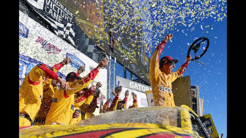 Joey Logano and his crew celebrate in Victory Lane after winning the NASCAR Sprint Cup race in Talladega, Alabama, on Sunday, October 23.
