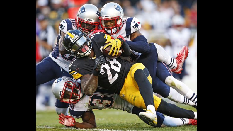 Pittsburgh running back Le'Veon Bell is tackled by New England Patriots during an NFL game in Pittsburgh on Sunday, October 23.