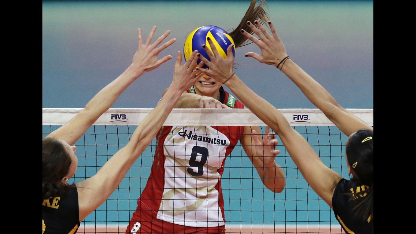 Lonneke Sloetjes, left, and Milena Rasic -- two players with VakifBank Istanbul -- block the shot of Hisamitsu Springs' Maja Tokarska during a volleyball match in Pasay, Philippines, on Tuesday, October 18.