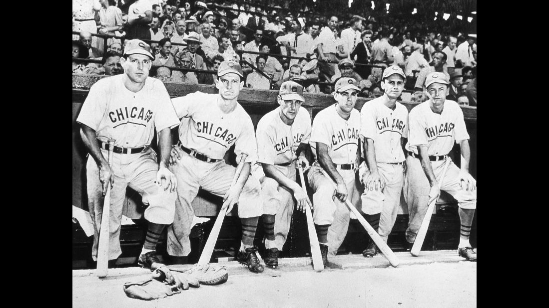 Chicago Cubs players pose outside of the dugout prior to game four.