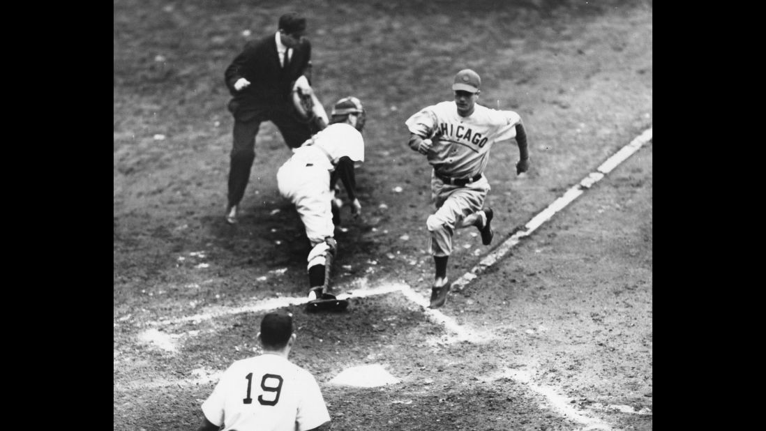 Cubs' Mickey Livingston scores a run past Detroit  catcher Paul Richards during game three of the 1945 World Series.