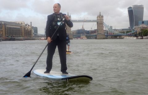 In London Andy Mitchell, the CEO of Tideway Tunnel, a sewer project for the River Thames, is pictured paddle boarding in front of the city's historic Tower Bridge. 