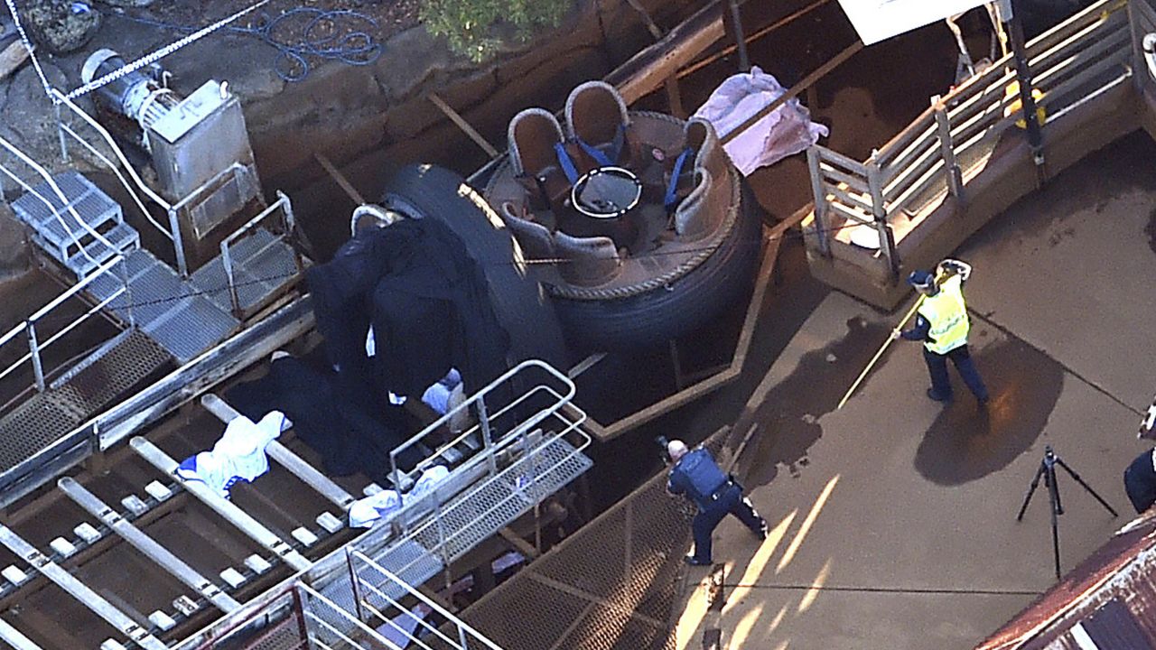 Queensland Emergency Services personnel are seen at the Thunder River Rapids ride at Dreamworld on the Gold Coast, Australia, Tuesday, Oct. 25, 2016. Four people died after a malfunction caused two people to be ejected from their raft, while two others were caught inside the ride at the popular theme park. (Dan Peled/AAP via AP)