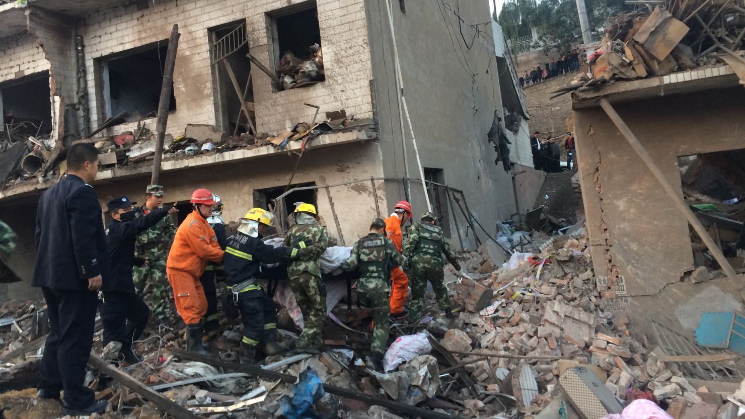 Rescuers work at the site of an explosion in Xinmin town on October 24, 2016 in Fugu County, China.