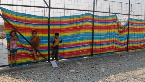 Children play in a shielded compound where women, traumatized by their experiences under ISIS, feel more protected.