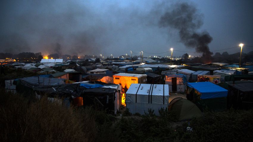 CALAIS, FRANCE - OCTOBER 24: Bonfires illuminate the night sky as night falls on the Jungle migrant camp on October 24, 2016 in Calais, France. French authorities have begun to clear the estimated 7000 people from the Calais Jungle migrant and refugee camp ahead of its demolition. (Photo by Jack Taylor/Getty Images)
