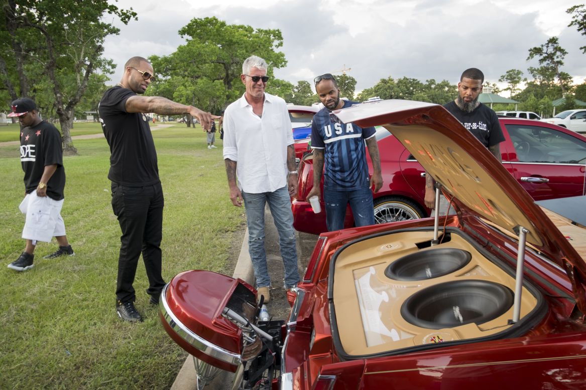 In Houston, musician Slim Thug (second from left) gave Bourdain a primer on Slab, the city's unique car culture. Among the key slab requirements? Candy-colored paint and elbow rims.