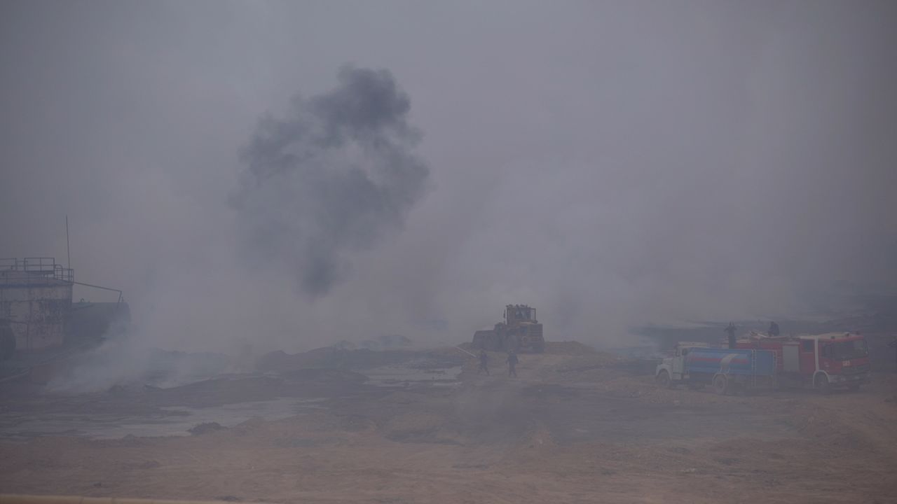 Hazardous chemical clouds fill the air at the sulfur factory near Qayyara on October 25.